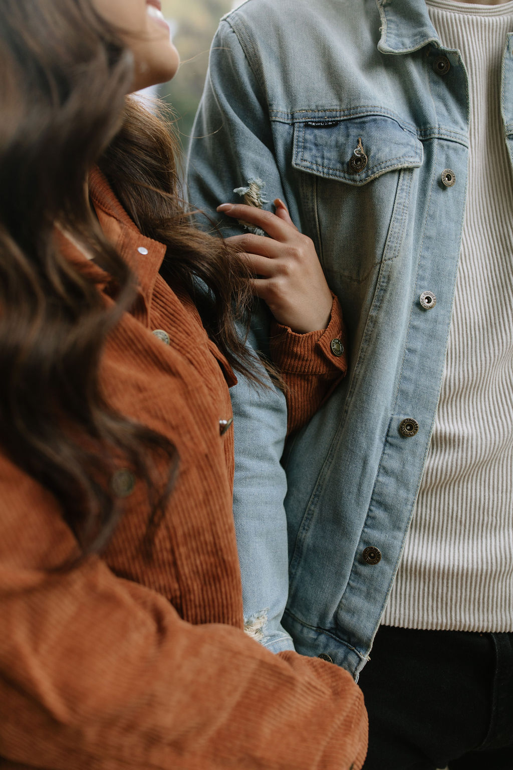 Up close photo of couple's engagement photoshoot outfits