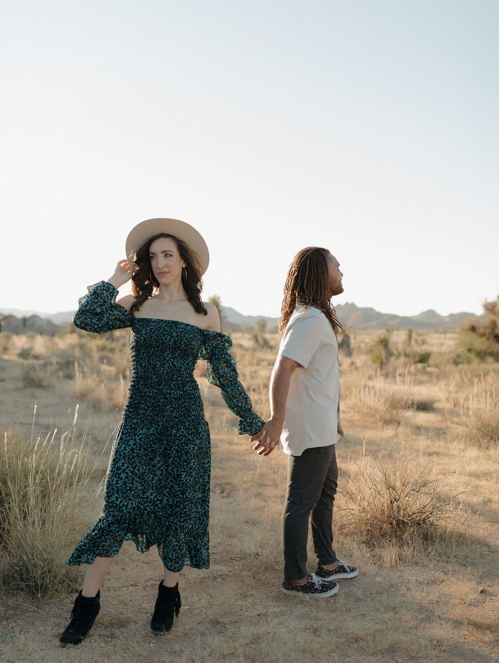 A couple holding hands in the desert in Joshua Tree