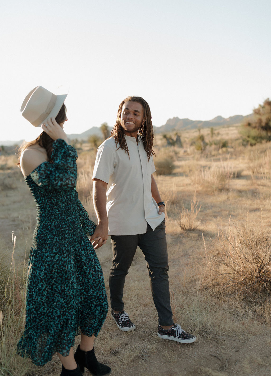 A couple walking through Joshua Tree hand in hand