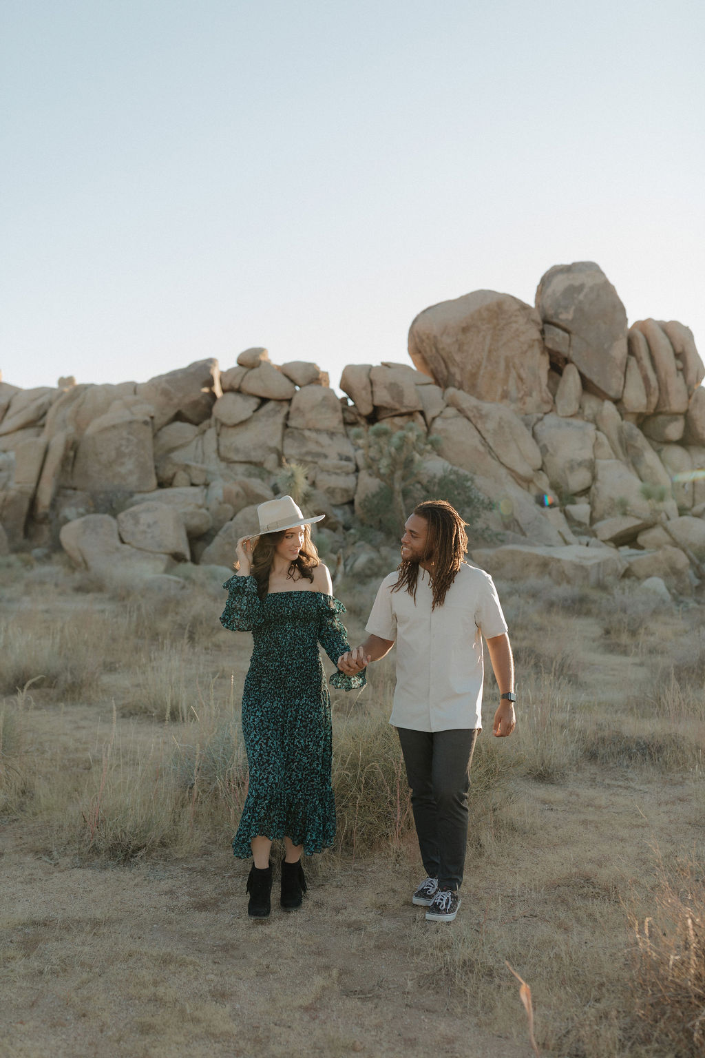 A couple holding hands in their Joshua Tree photoshoot