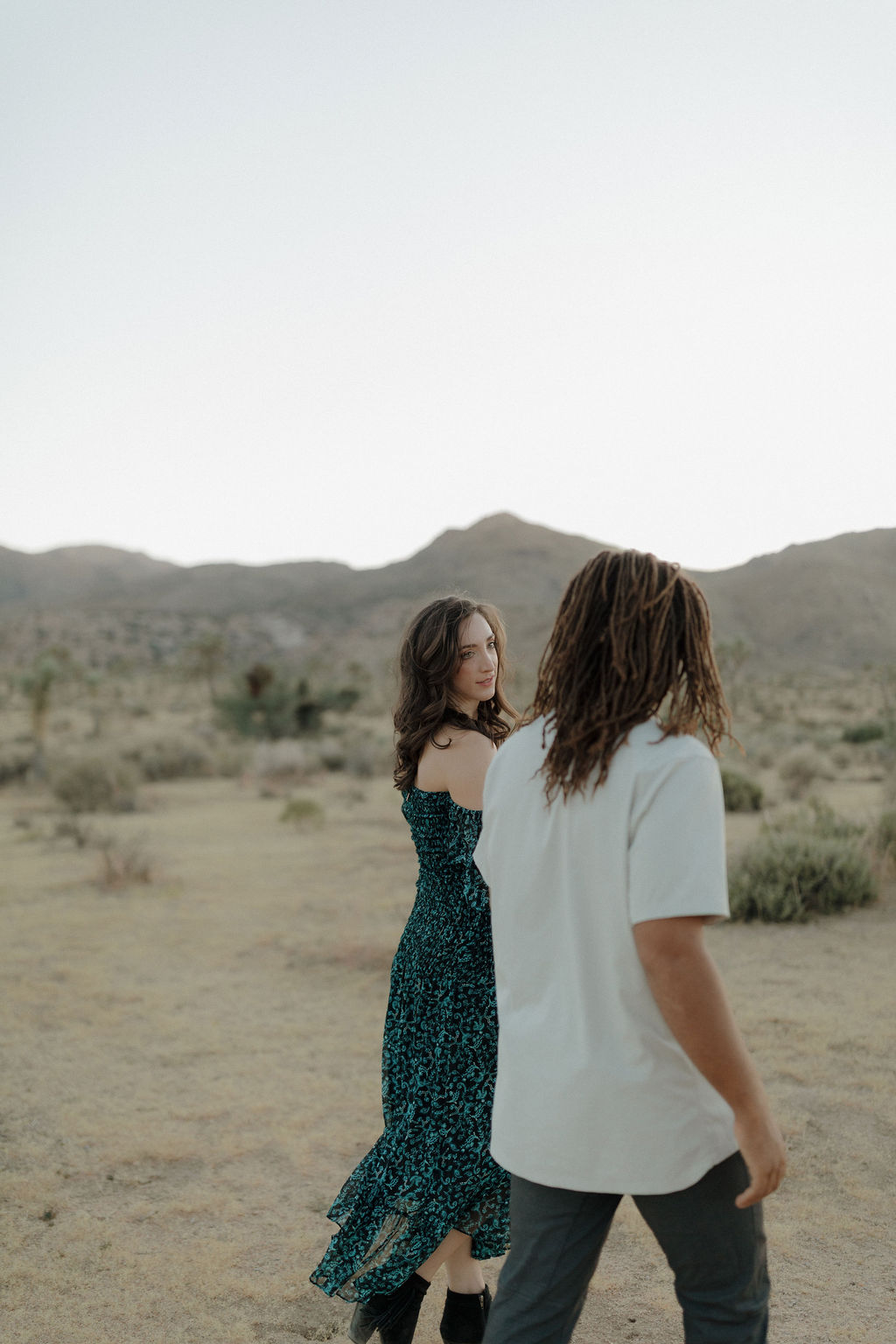 A couple walking through the desert at Joshua Tree