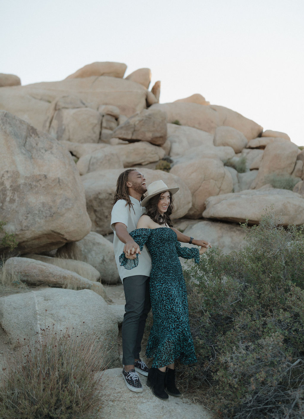A man and his fiancee posing for Joshua Tree engagement photos