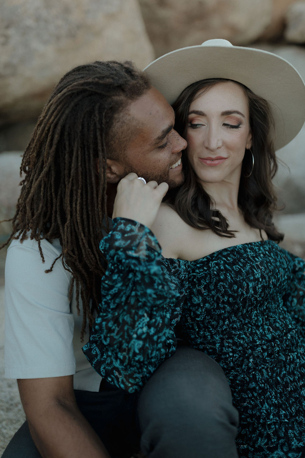 A man and his fiancee posing for Joshua Tree engagement photos