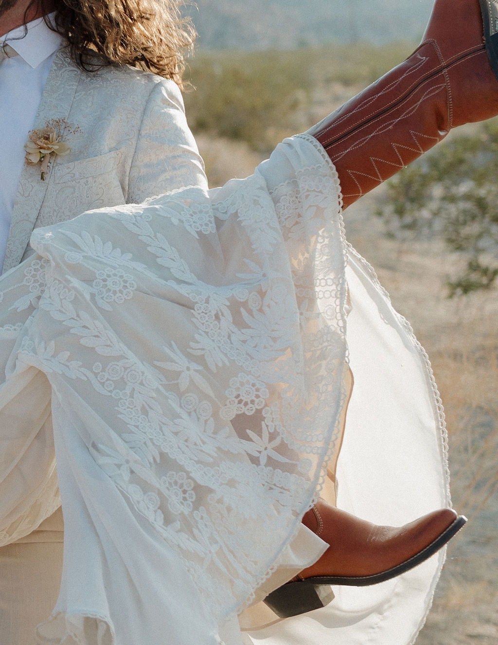 A bride wearing cowboy boots at a Joshua tree wedding