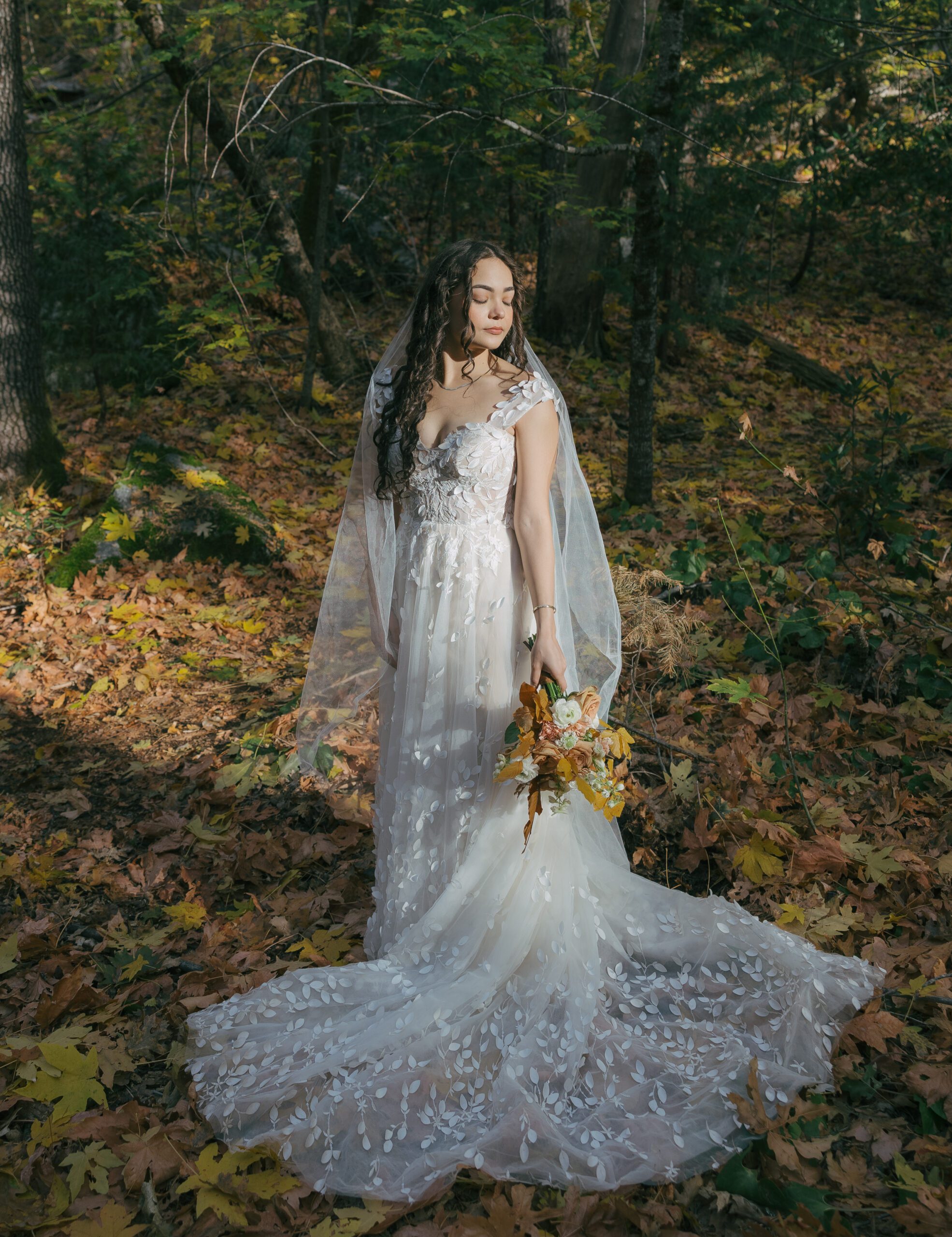 Bridal portrait with the light framing bride's face in the trees at Yosemite Park Elopement