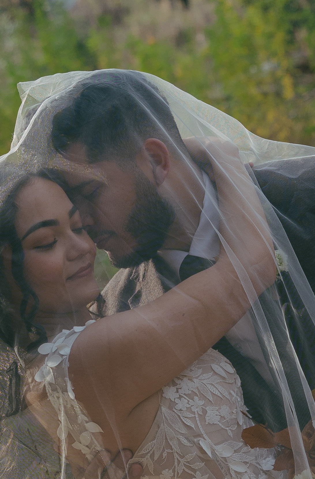Bride and groom under veil to pose for editorial Yosemite elopement photos