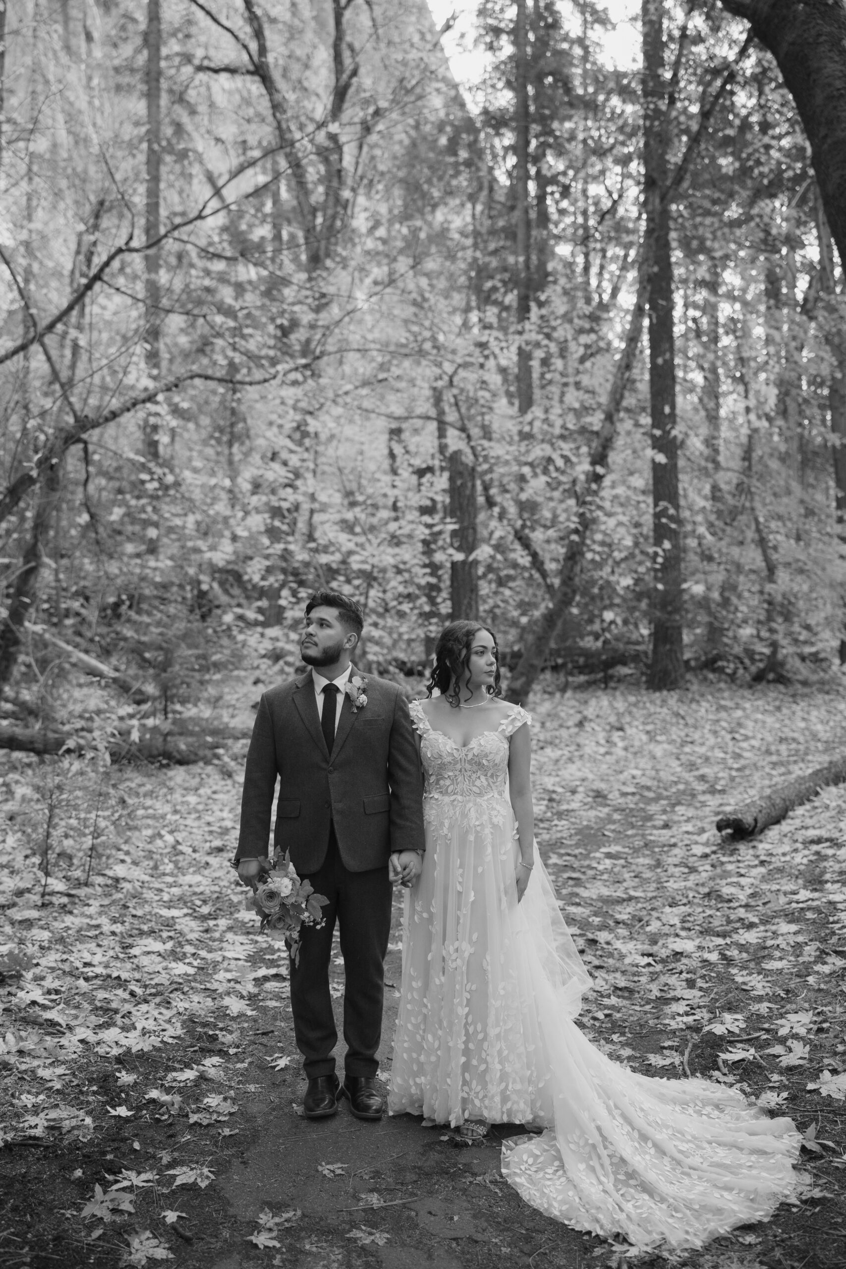 Editorial bride and groom photo of couple facing away from each other in the woods
