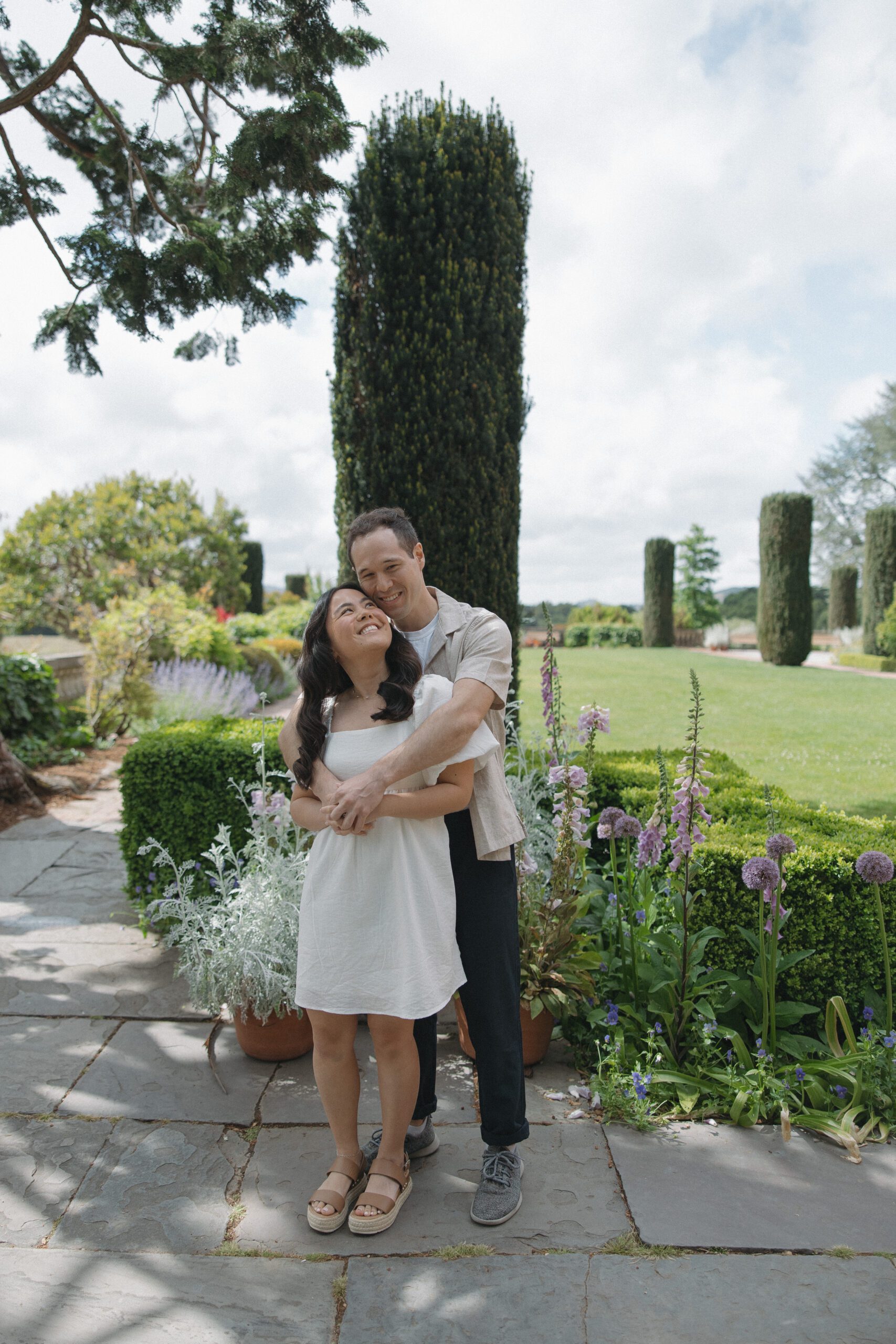 Couple engagement photo at Filoli gardens with vibrant gardens in background