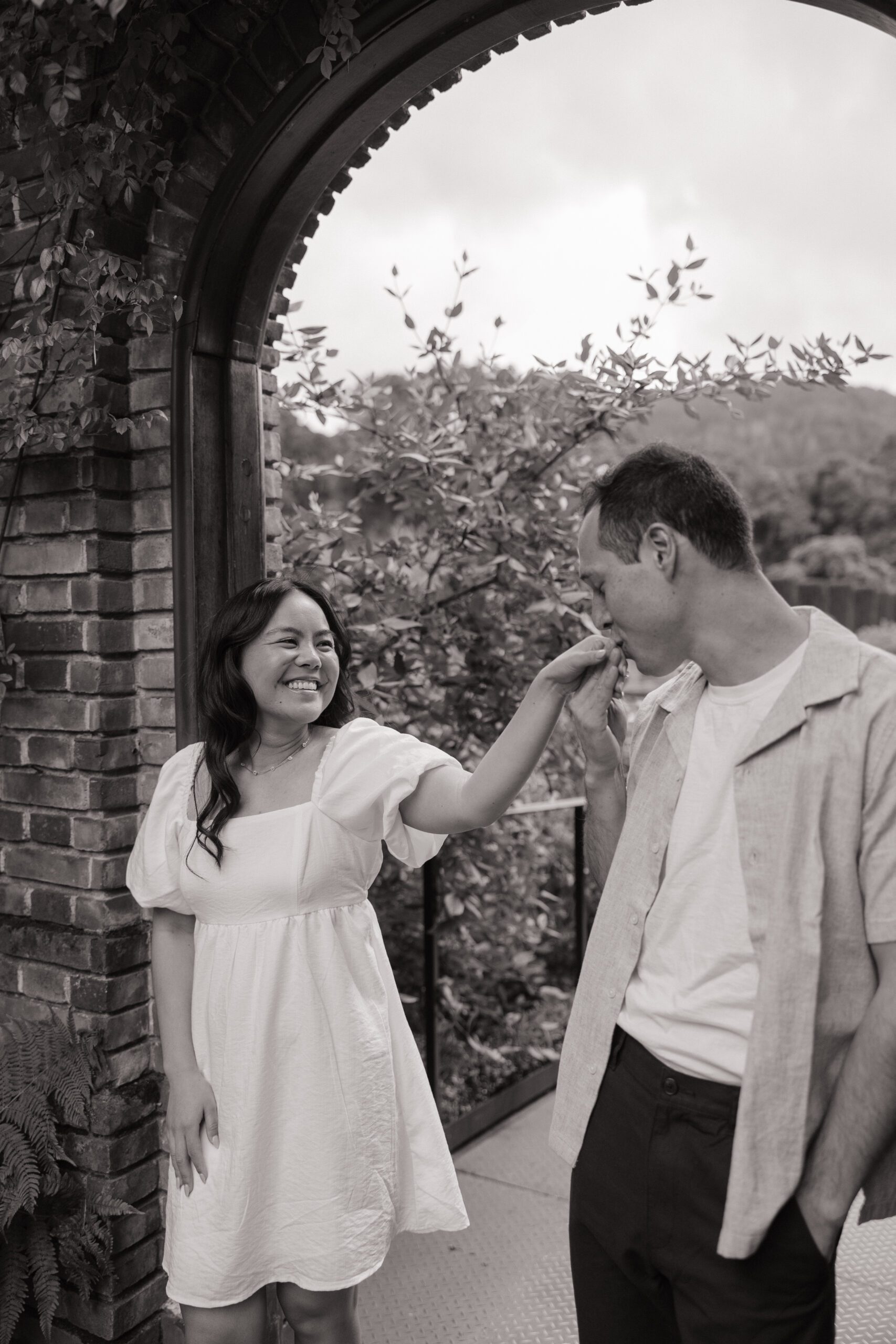 Man kissing his fiancees hand in engagement photoshoot