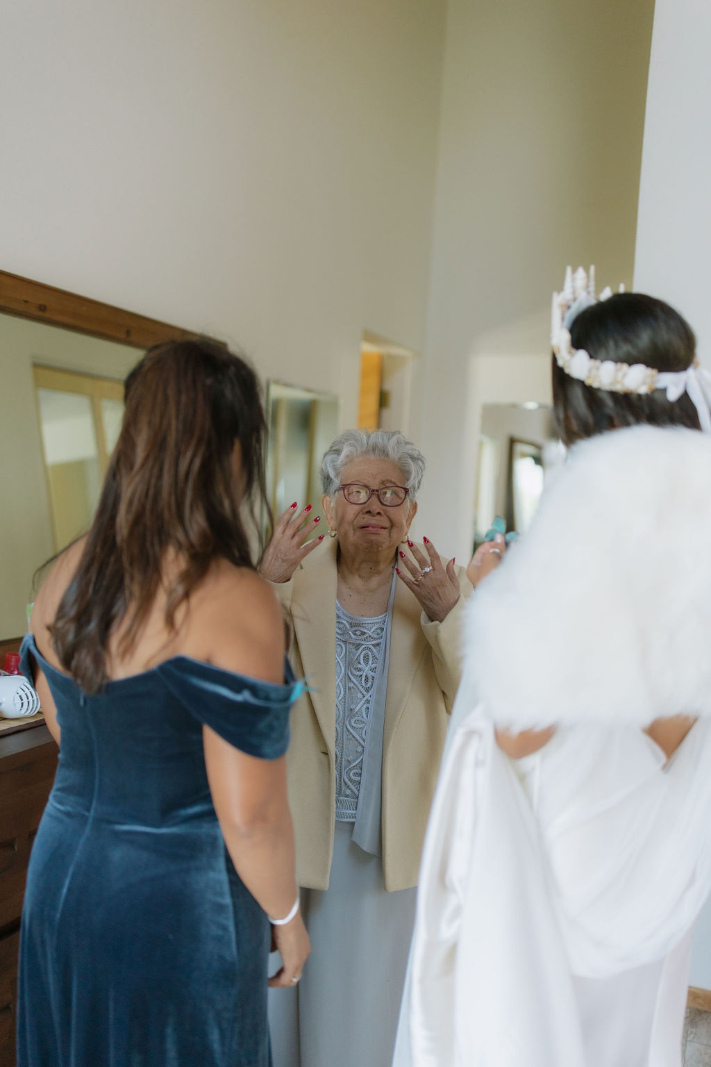 Grandmother crying seeing bride first look in her wedding dress