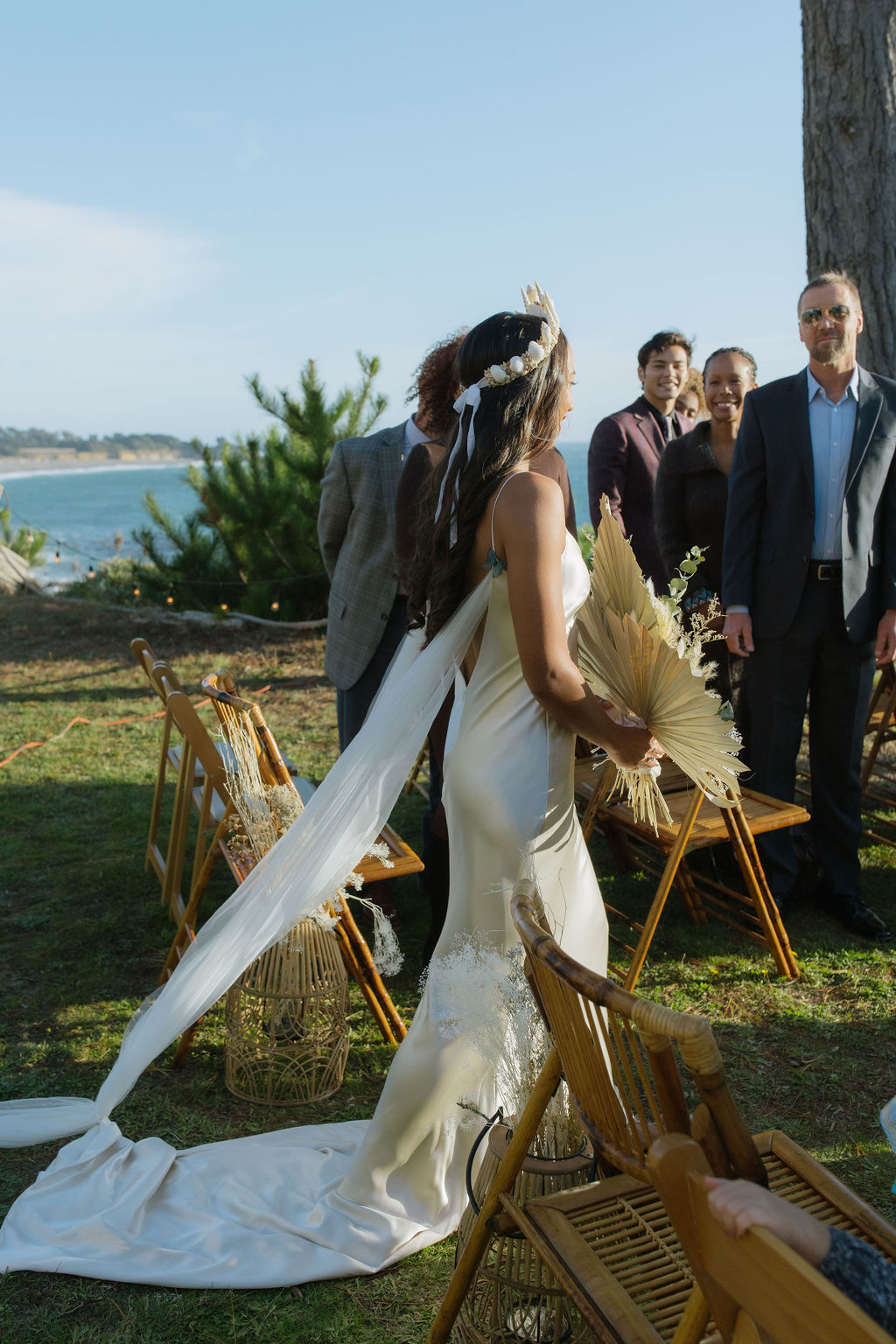 Bride walking down the aisle at coastal wedding