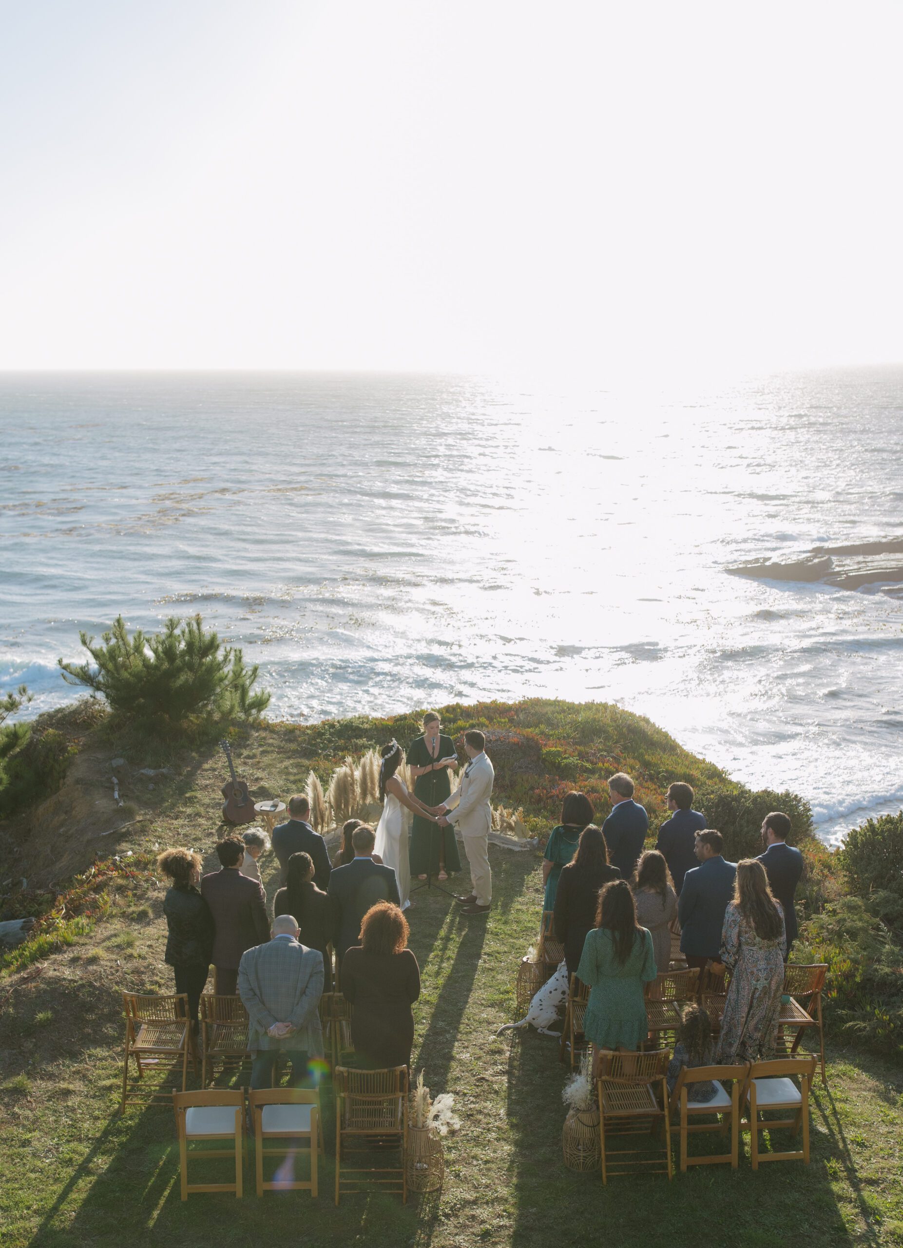 Bay Area intimate wedding ceremony from above with ocean below the couple who are standing on a cliff