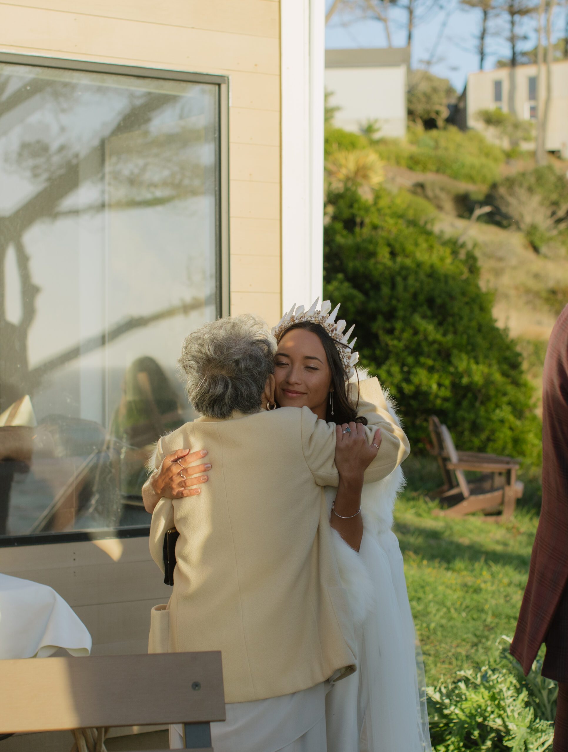Documentary wedding photo of bride hugging her grandma
