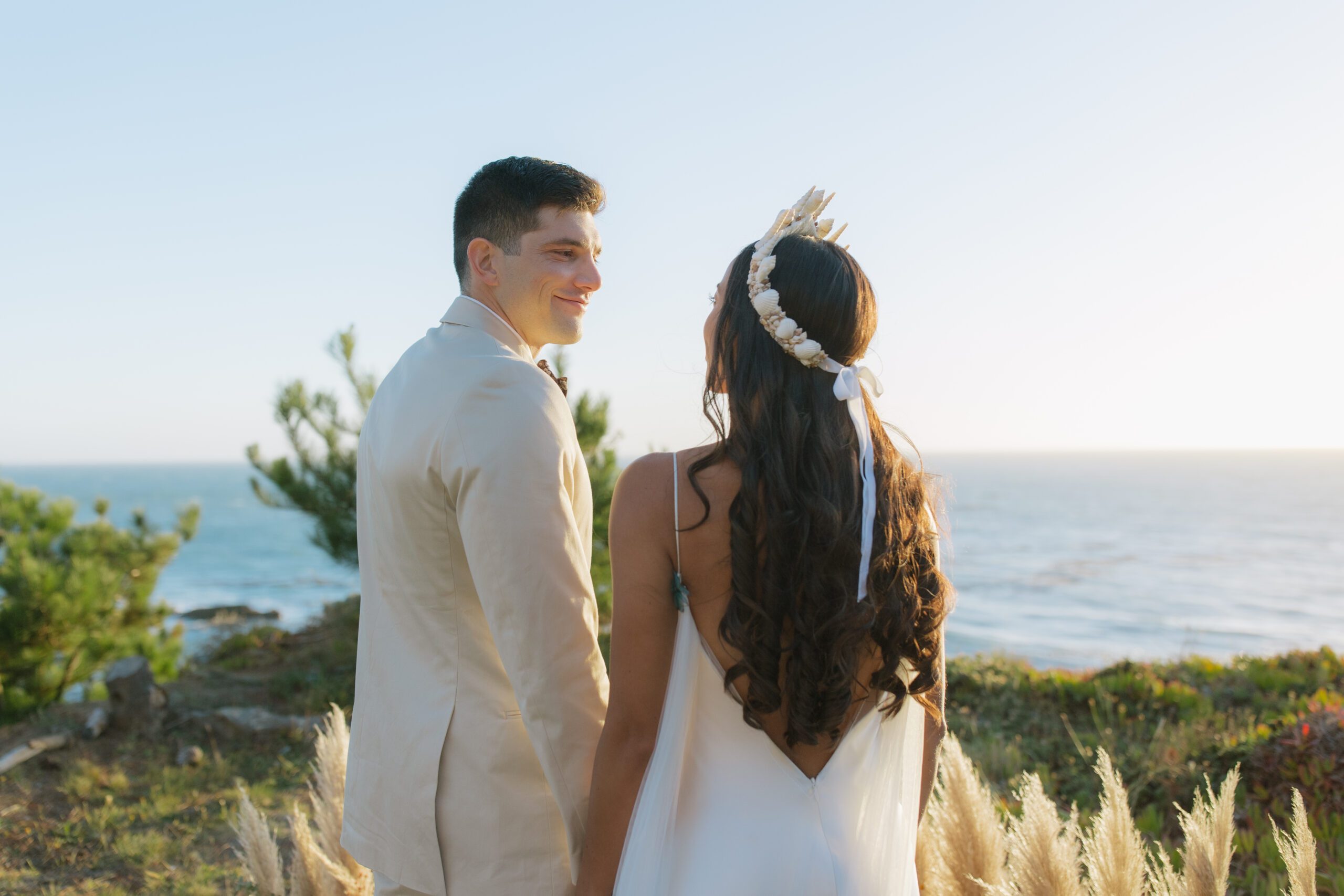 Romantic bride and groom beach photo of them smiling at each other