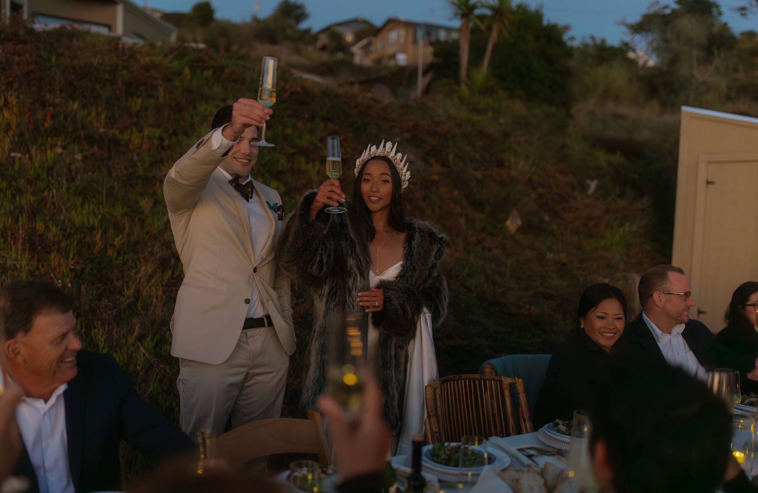Bride and groom during toasts holding their glasses during intimate wedding reception