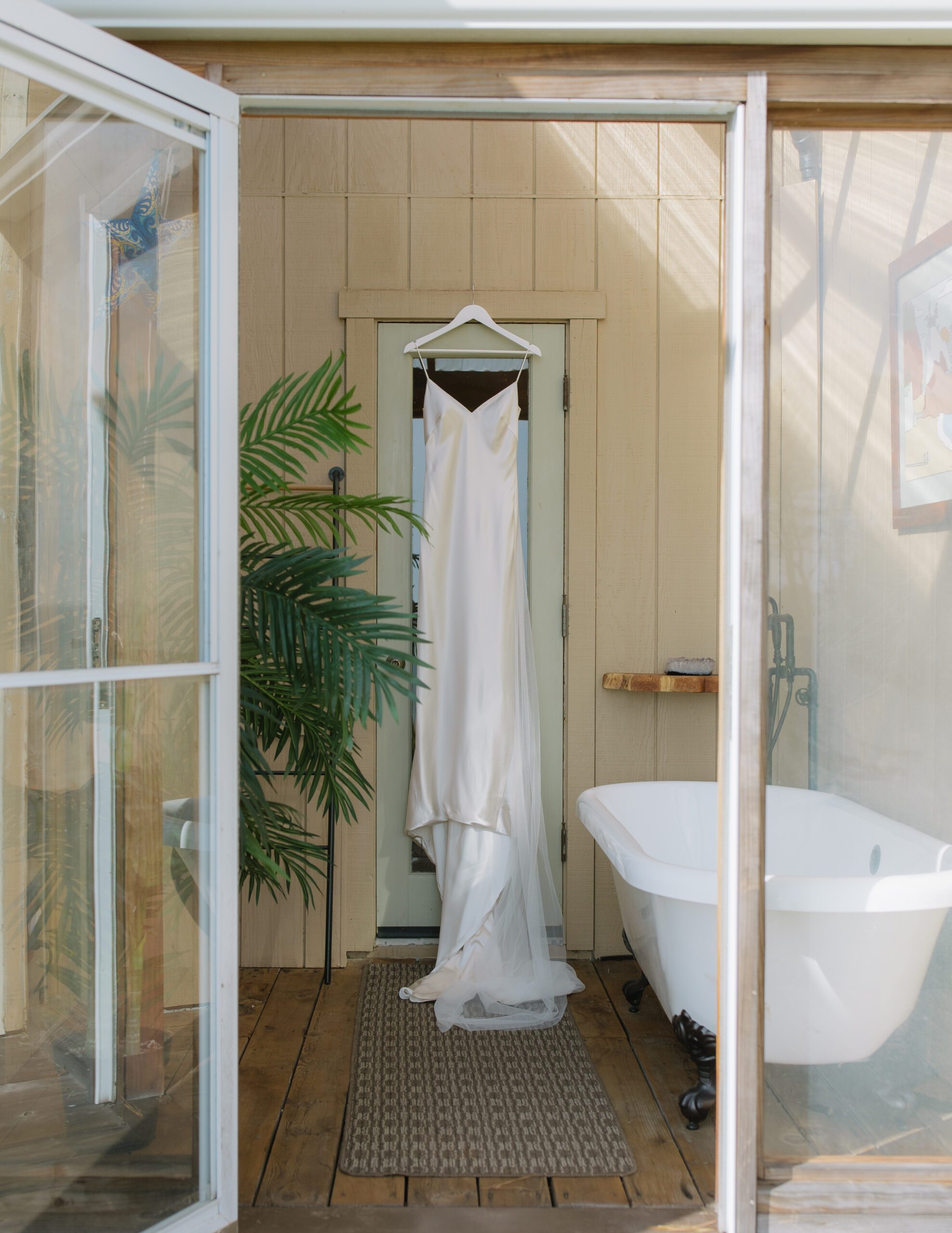 Wedding dress hanging at coastal house from Bay Area wedding