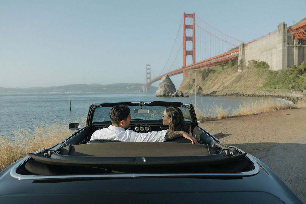 Golden Gate Bridge engagement photos with couple in a classic car