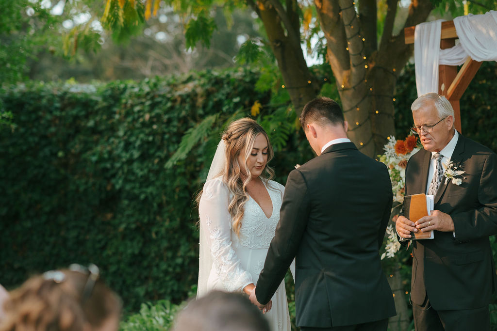 Couple praying during intimate wedding ceremony