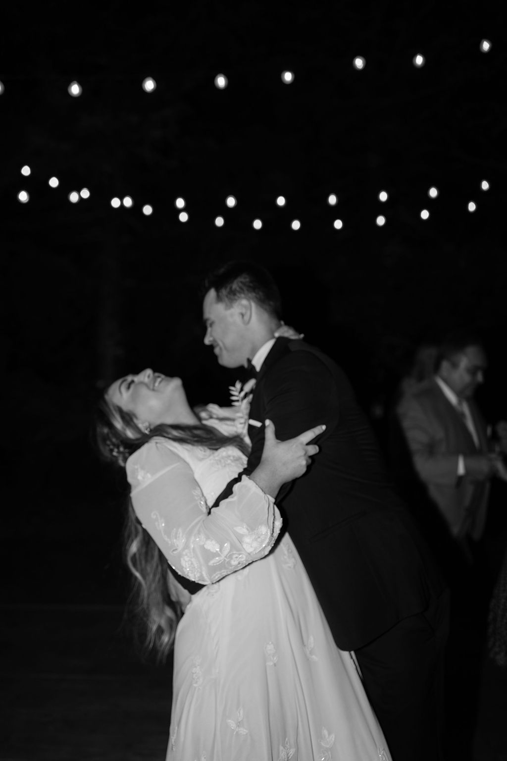 Black and white wedding photo of bride and groom dancing at their outdoor wedding reception in Northern California