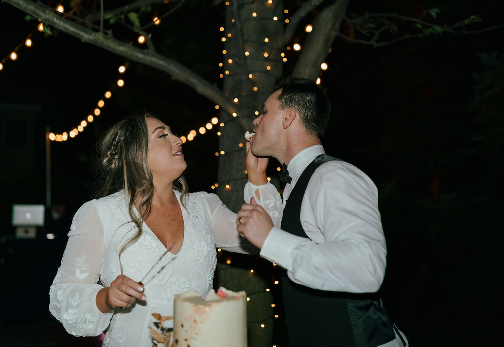 Cake cutting wedding photo of bride and groom