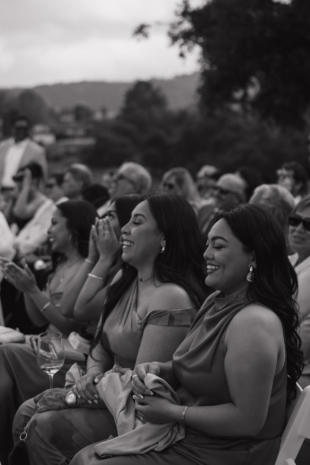 The guests during the wedding ceremony, laughing and crying