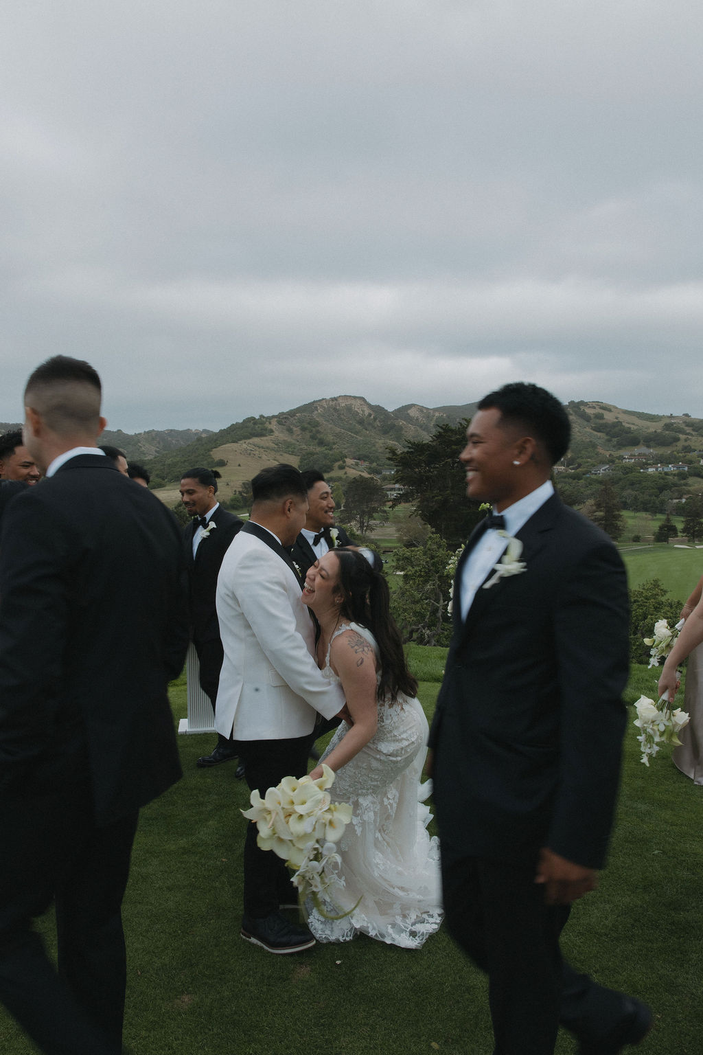 Bride falling down from laughing so hard during bridal party photos