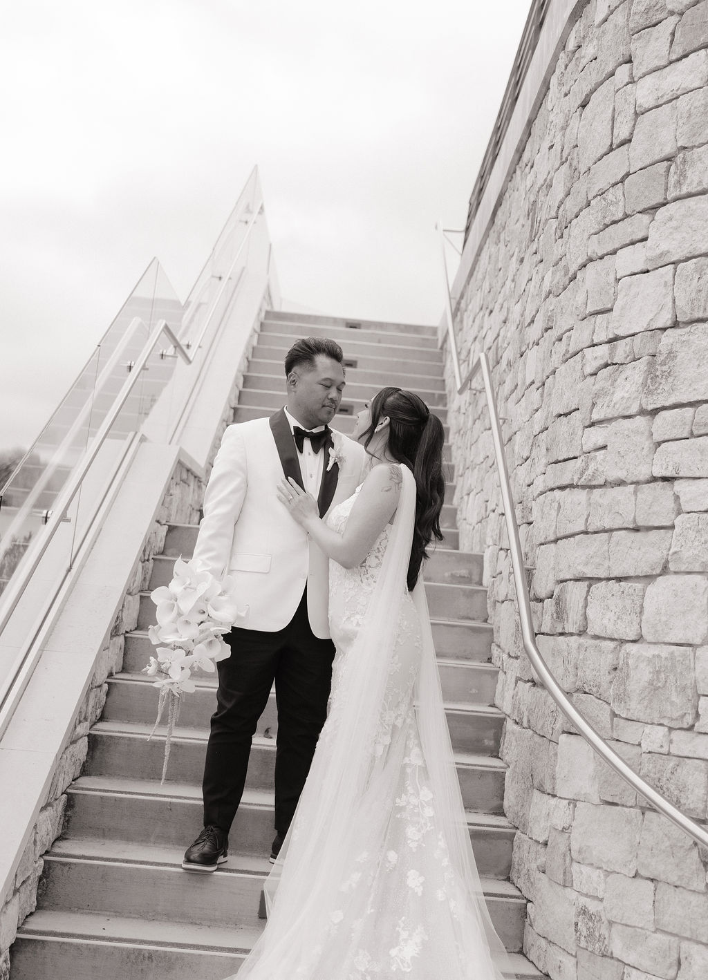 Black and white bride and groom photo on a staircase at Monterey wedding venue
