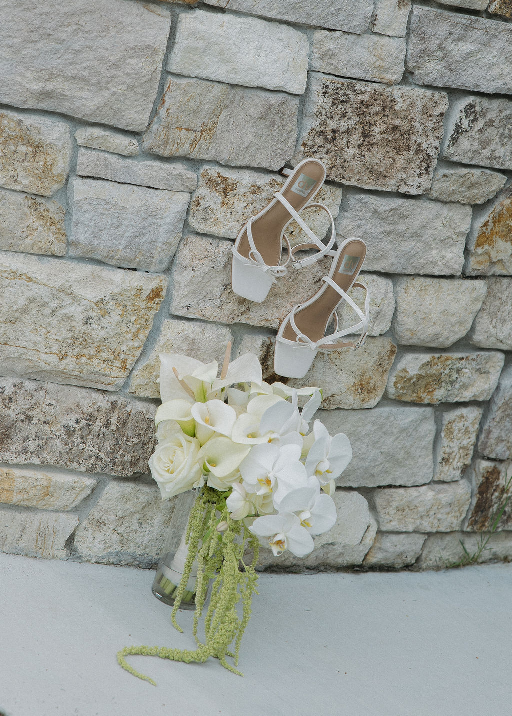 Wedding detail photos with a lily bouquet and wedding shoes