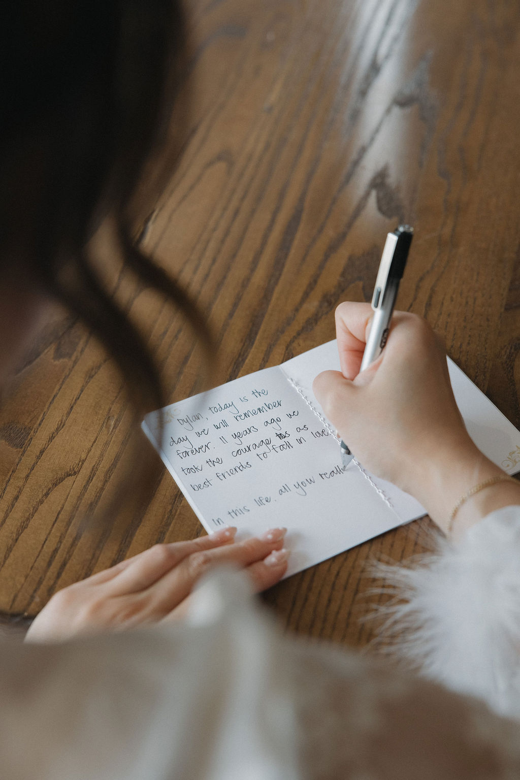 Bride writing wedding vows before ceremony
