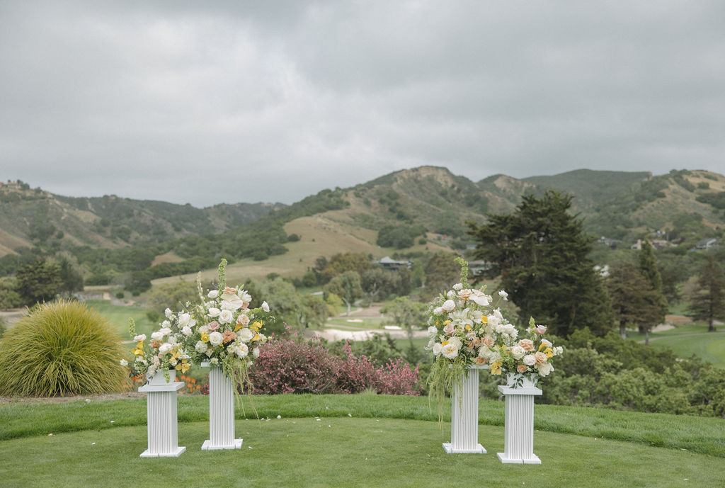 Ceremony setup at Northern California wedding venue with pastel wedding flowers on columns