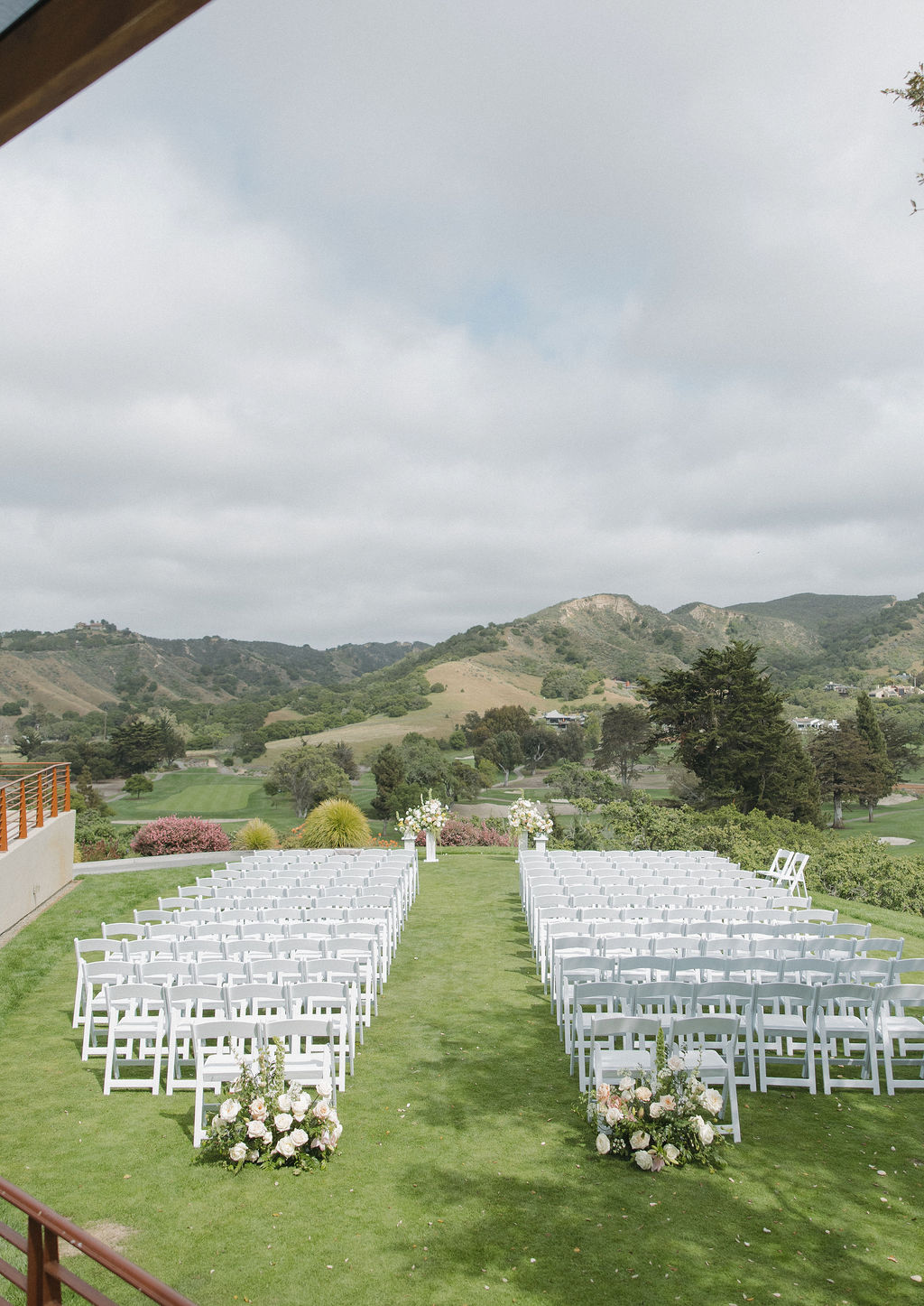 Ceremony setup with pastel wedding flowers at Monterey wedding venue