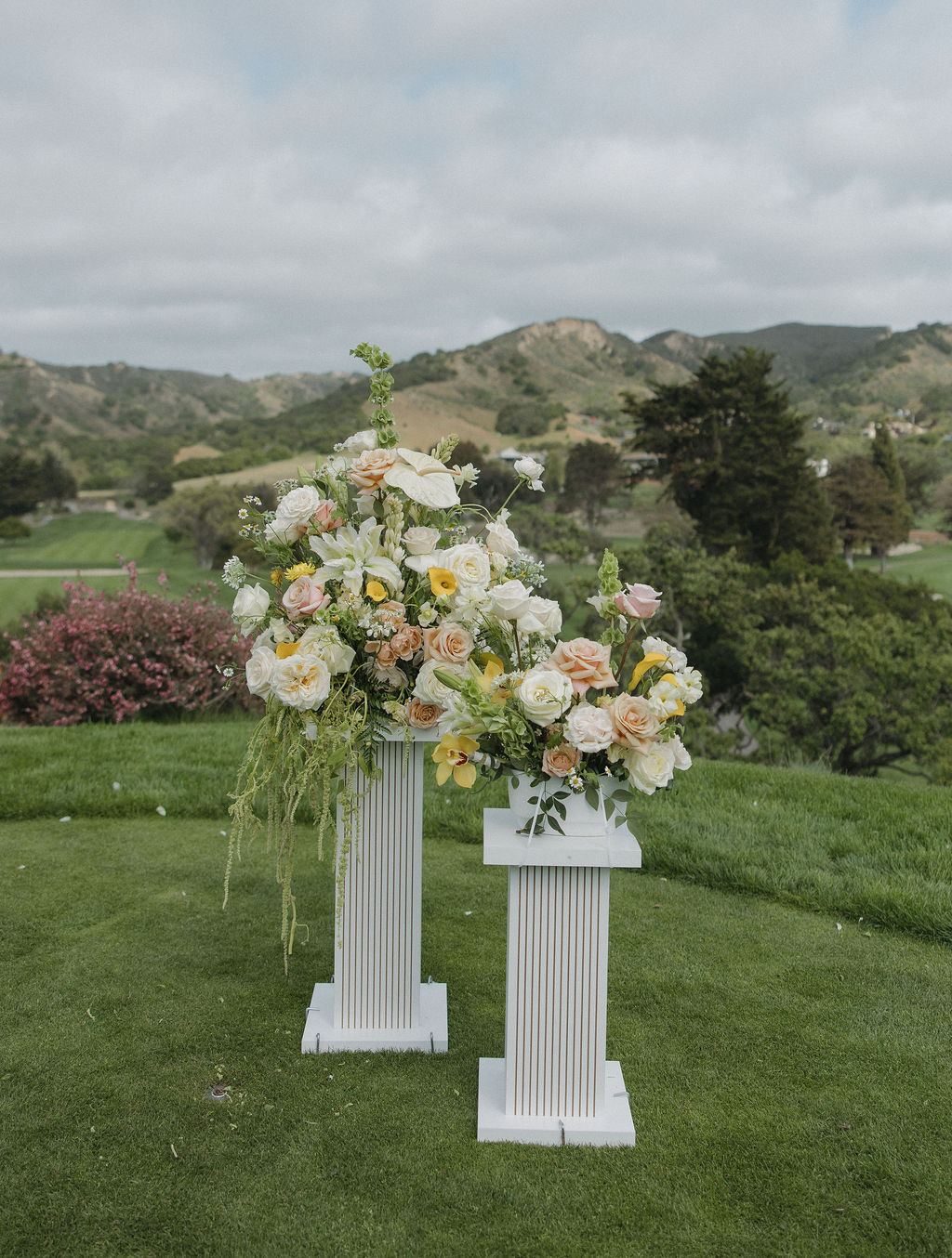 Pastel wedding flowers on columns at Monterey wedding venue