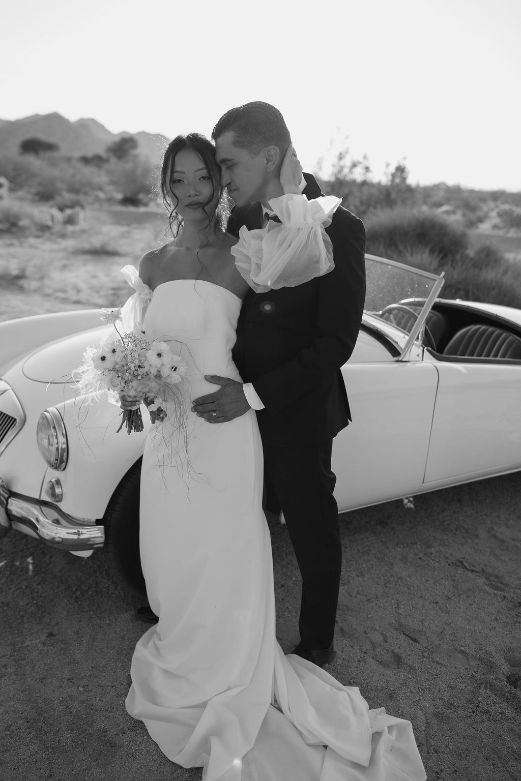 Black and white editorial photo of bride and groom at Joshua tree wedding