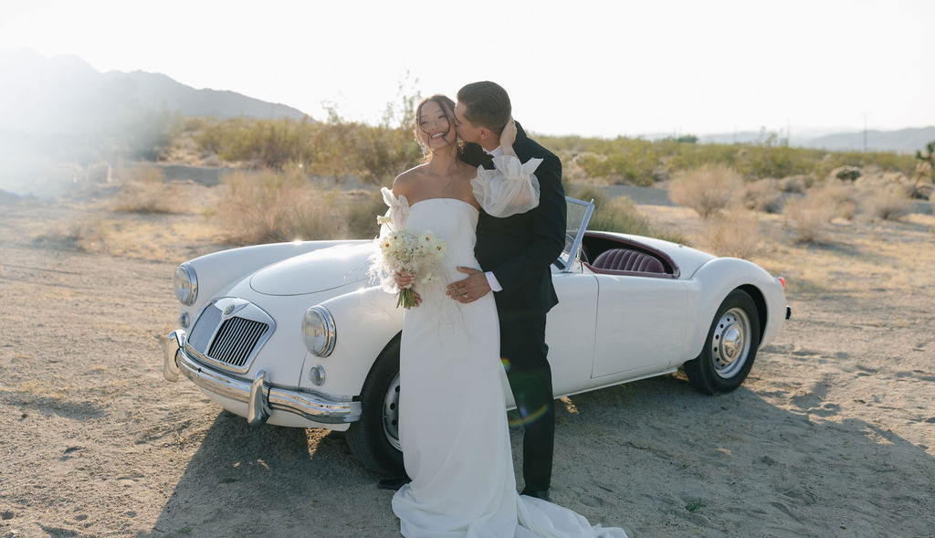 Joshua tree wedding with vintage car, portrait of bride and groom