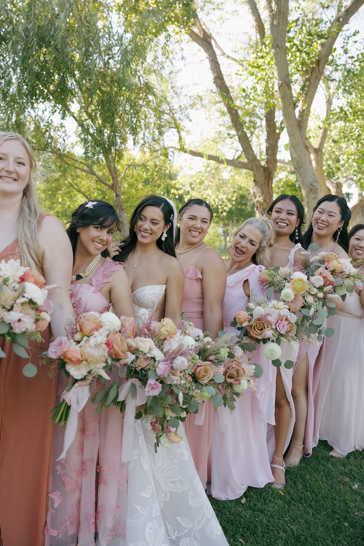 Bridal party photos of bride smiling at bridesmaids
