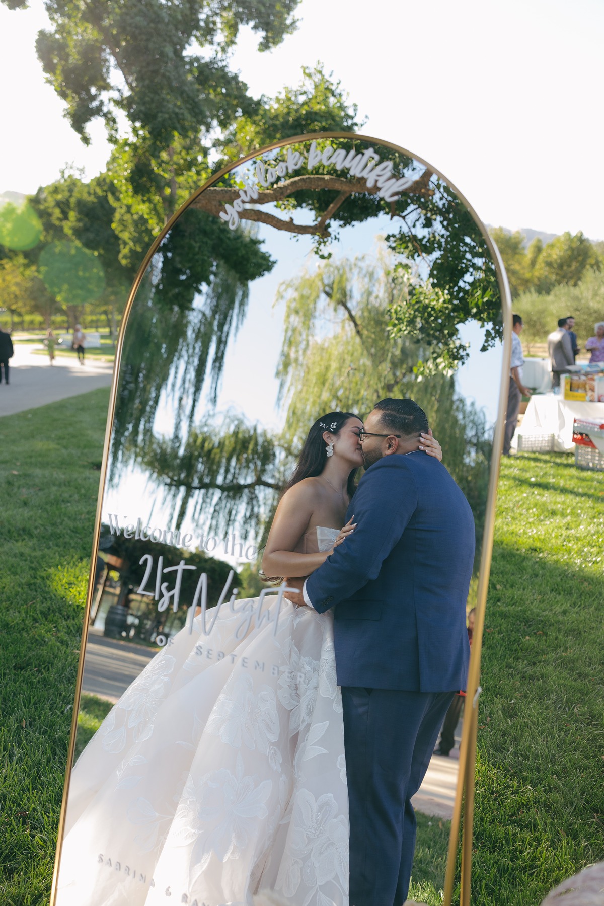Bride and groom kissing in mirror as luxury wedding decor
