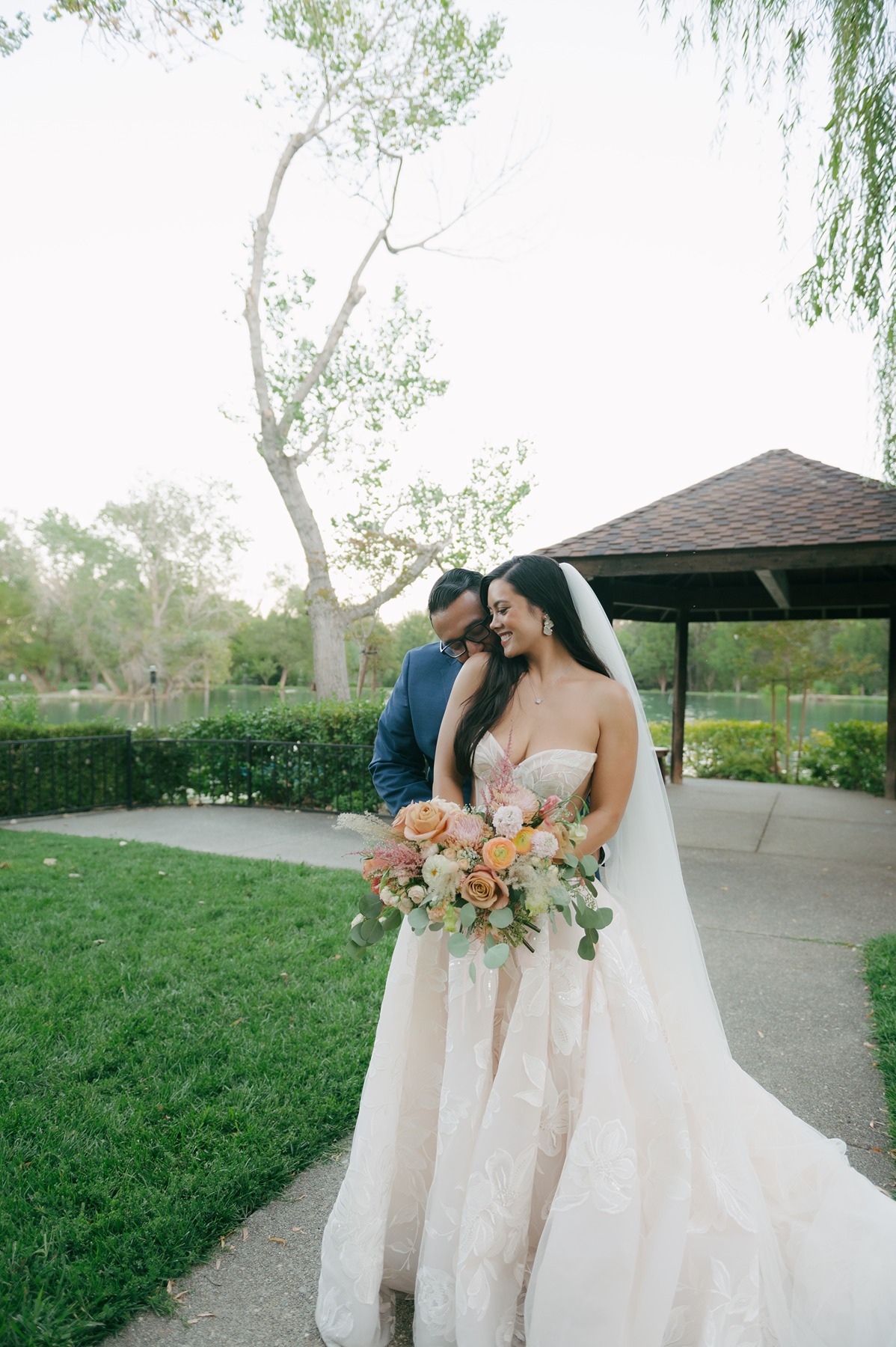 Bride and groom posing for a romantic photo during their wedding photos