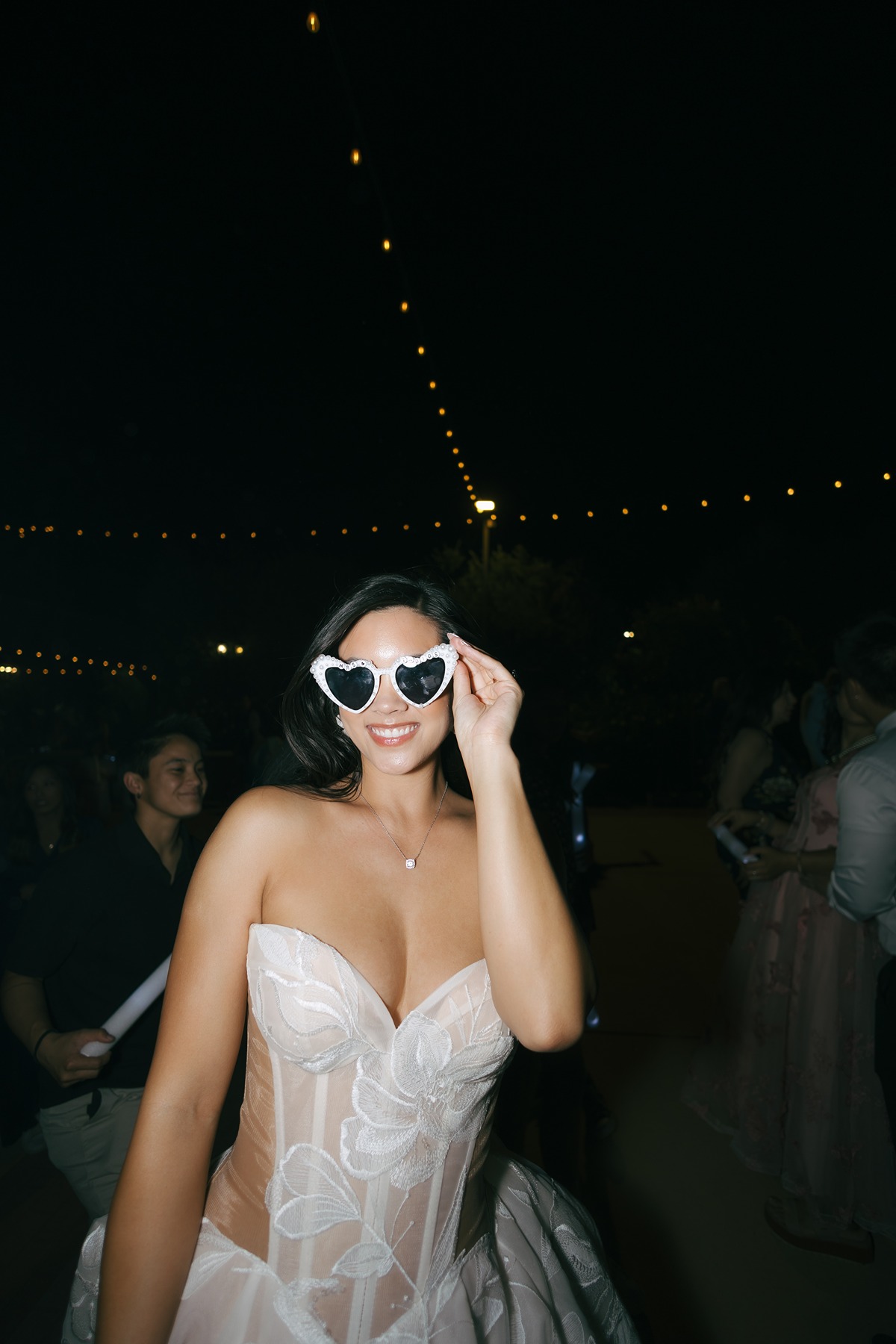 Bride in sunglasses at wedding reception with direct flash photo