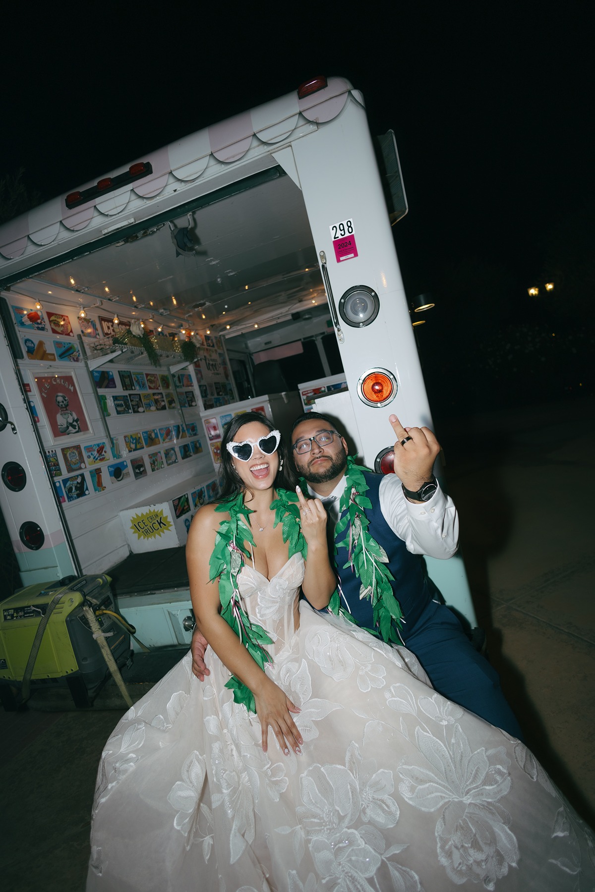 Bride and groom showing off their rings in their wedding ice cream truck