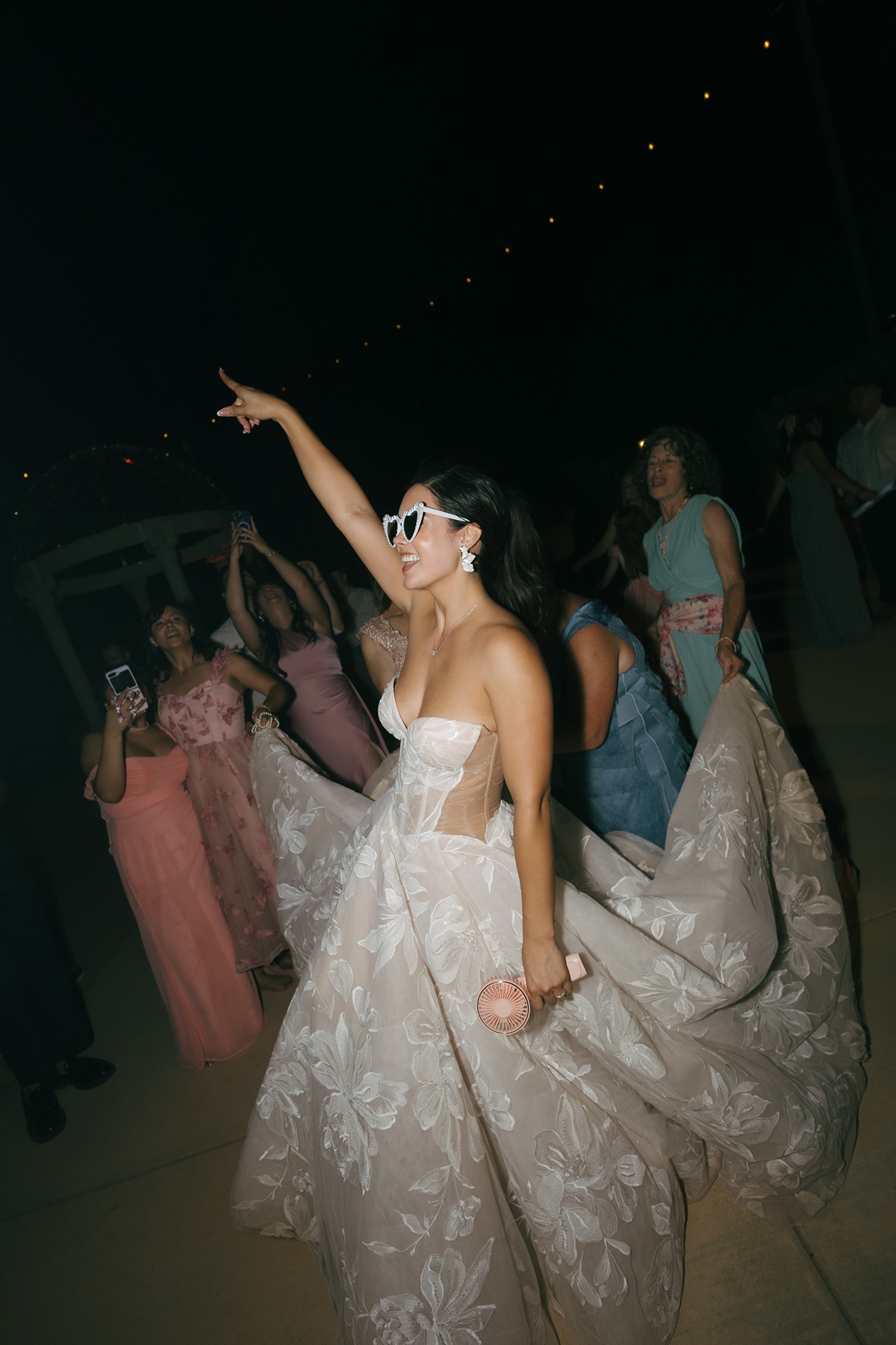 Bride dancing at wedding reception wearing bridal sunglasses