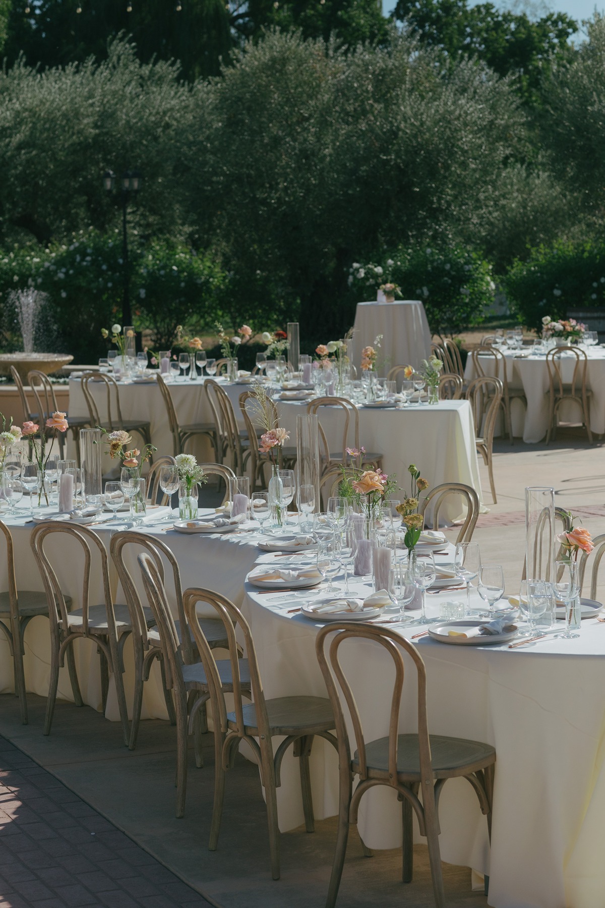 Luxury wedding table setup with curved tables and pastel floral centerpieces