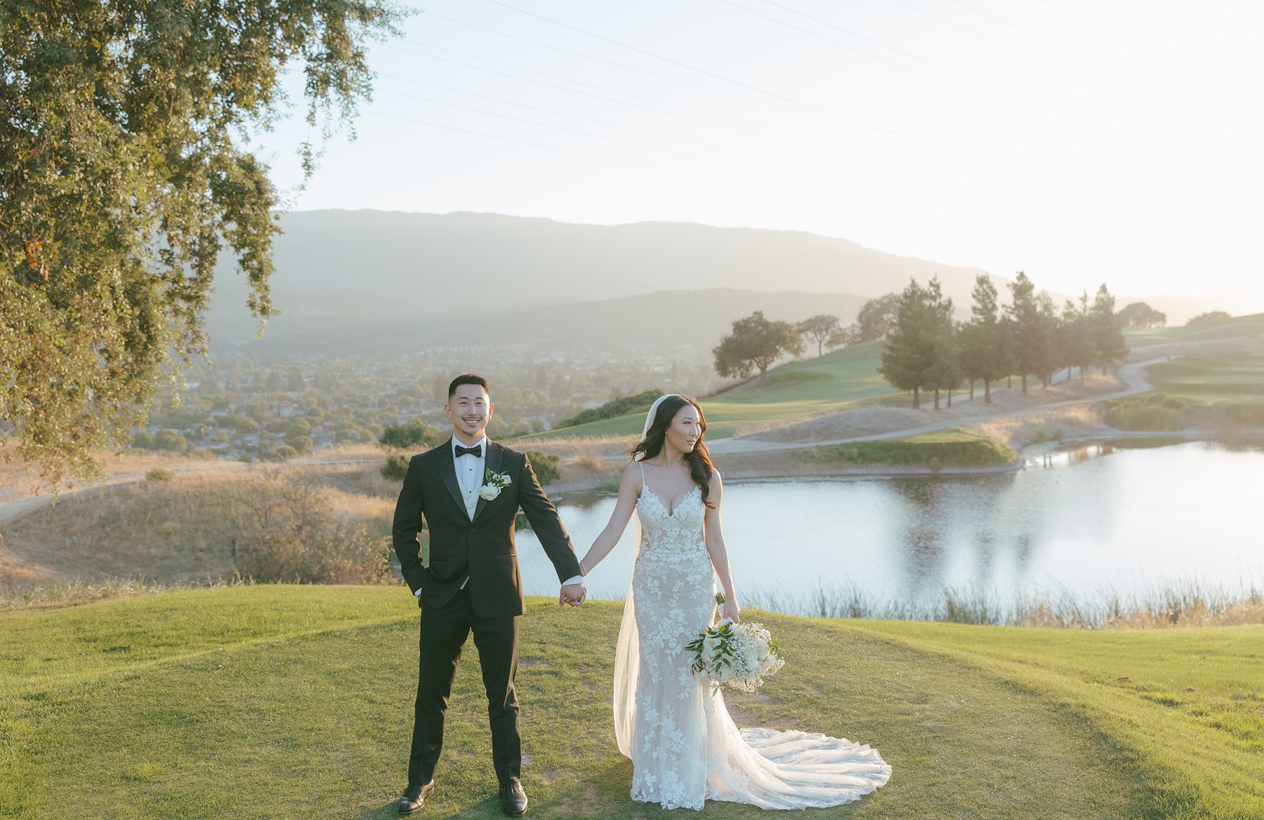 Bride and groom posing for wedding photos on a golf course at San Jose wedding venue
