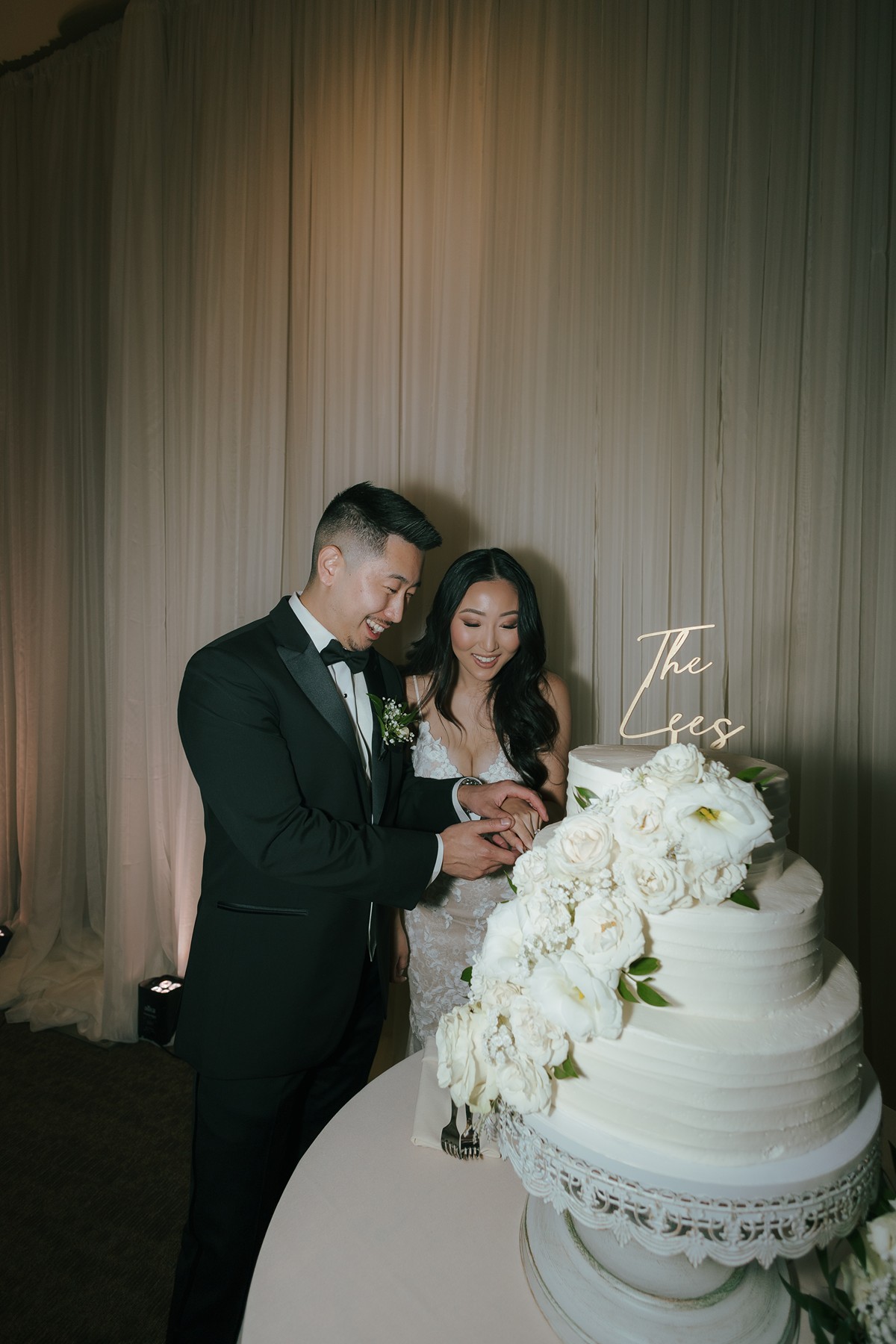 Bride and groom cutting their cake at their wedding reception