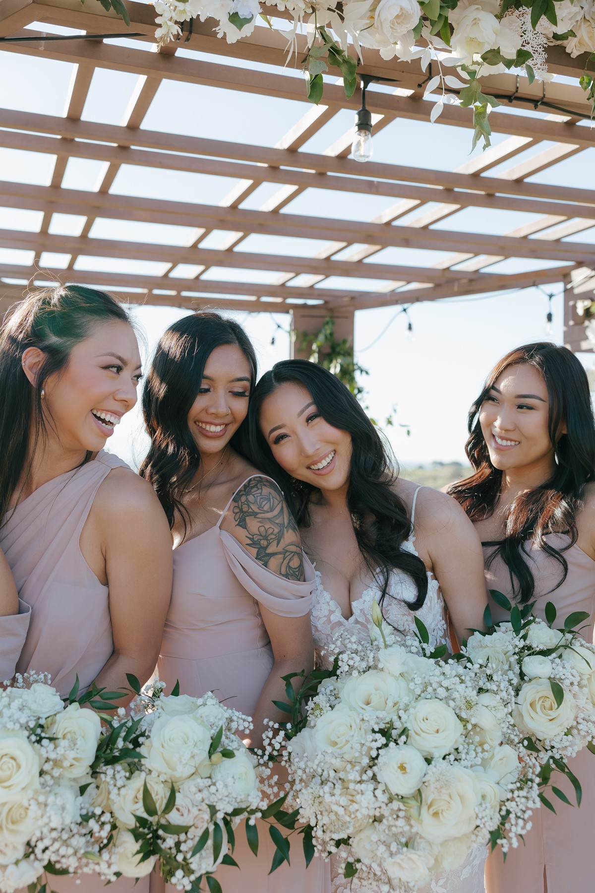 Bridesmaid photo with bride laughing and leaning her head on her maid of honor