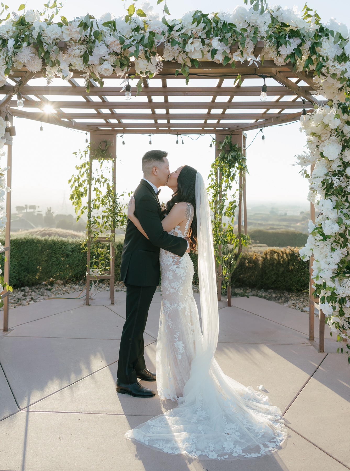 Bride and groom share their first kiss at their simple wedding ceremony