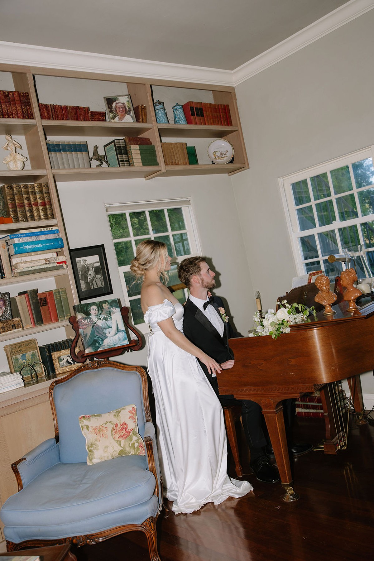 Couple posing by a piano in direct flash wedding photo