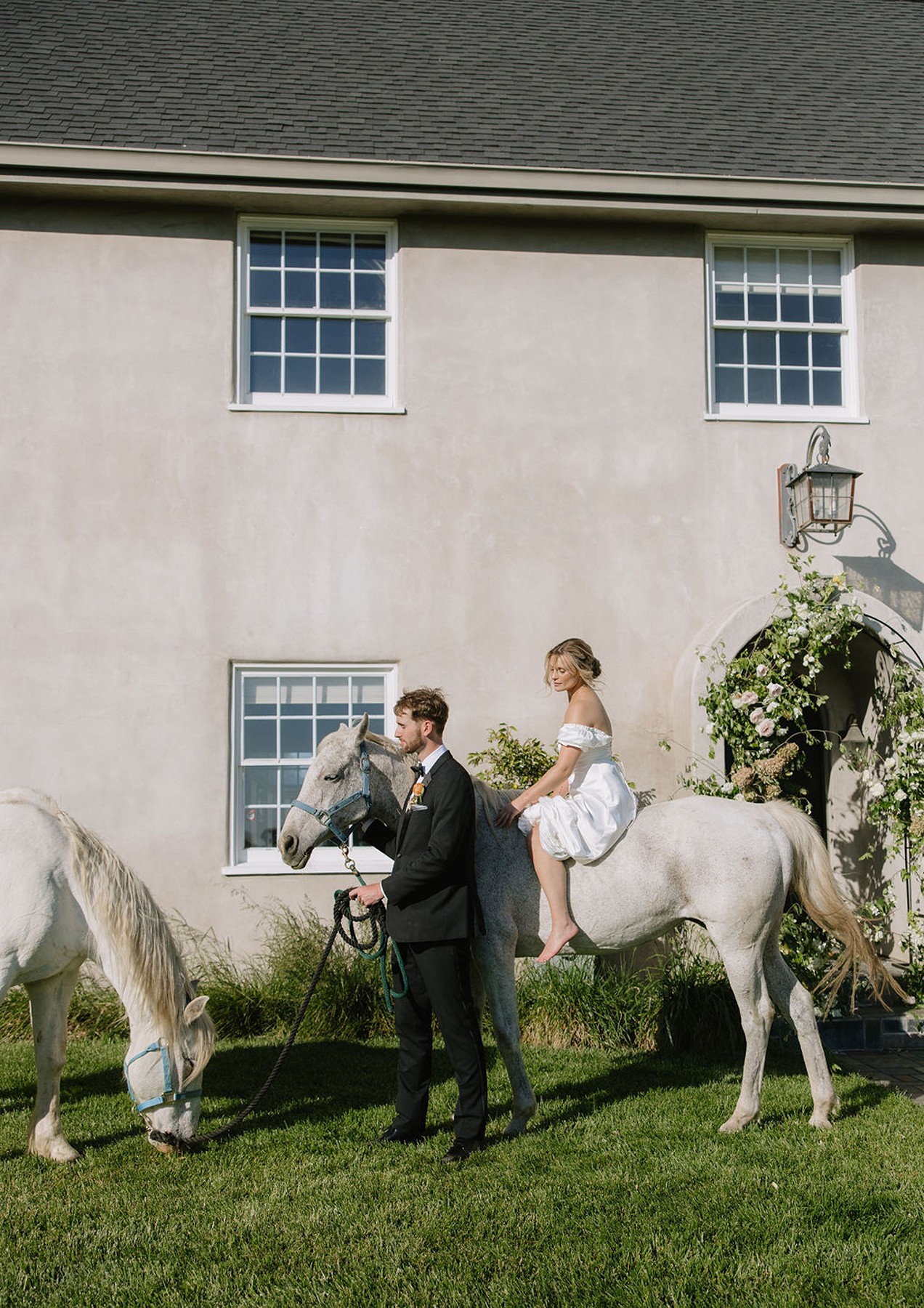 Groom walking next to bride riding a horse at Cavaignac, a country estate
