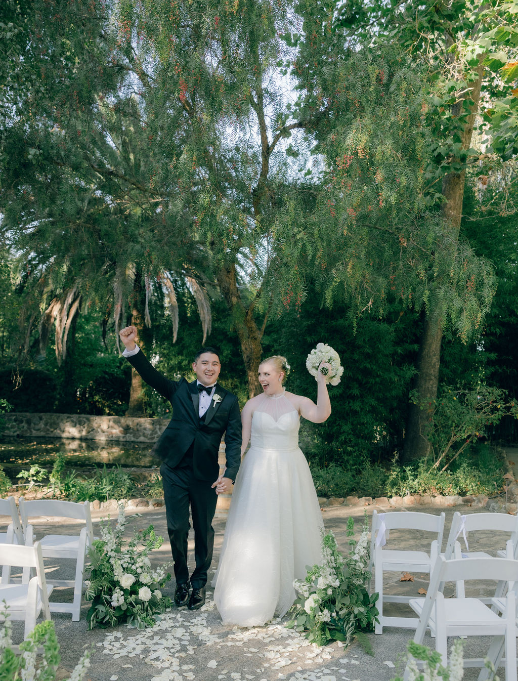 Bride and groom cheering after their wedding ceremony