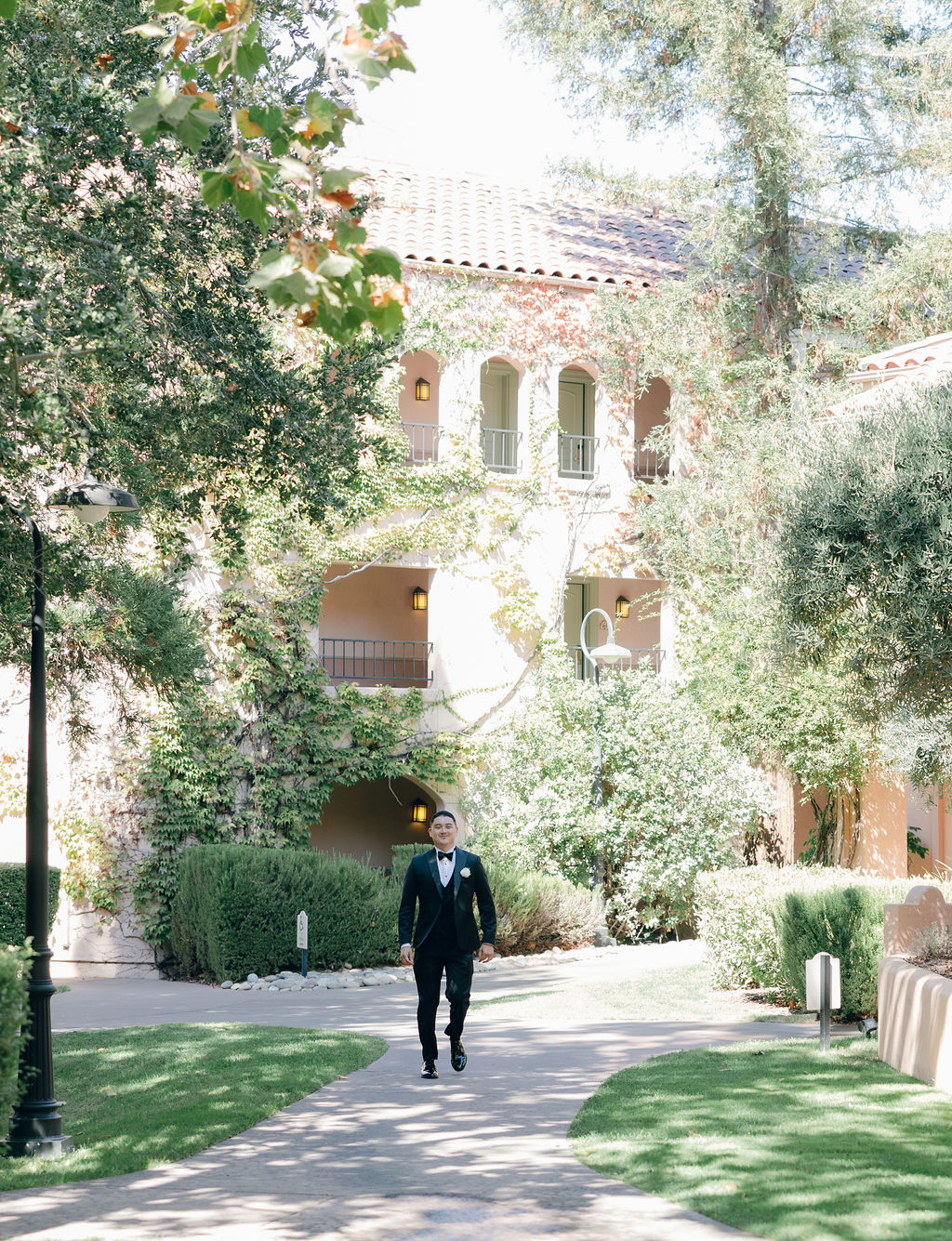 Groom walking through Cline Family Cellars courtyard