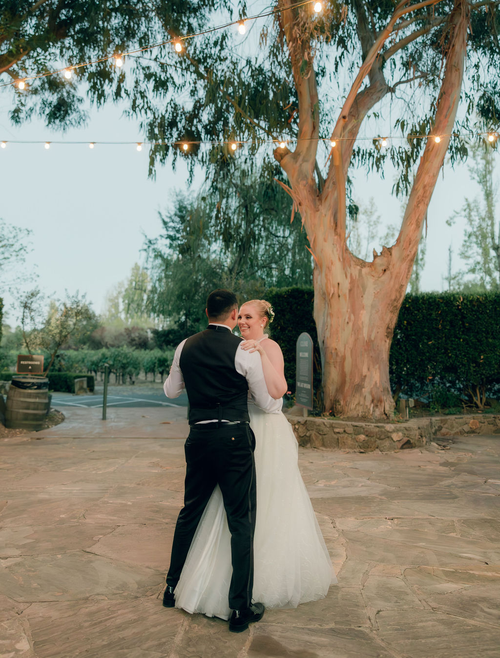 Bride and groom sharing their first dance at courtyard of Napa Valley venue for weddings